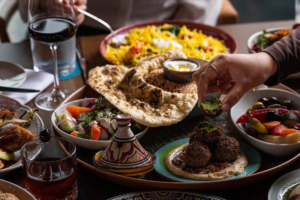 An assortment of Darya's lunch dishes sitting on a dark table