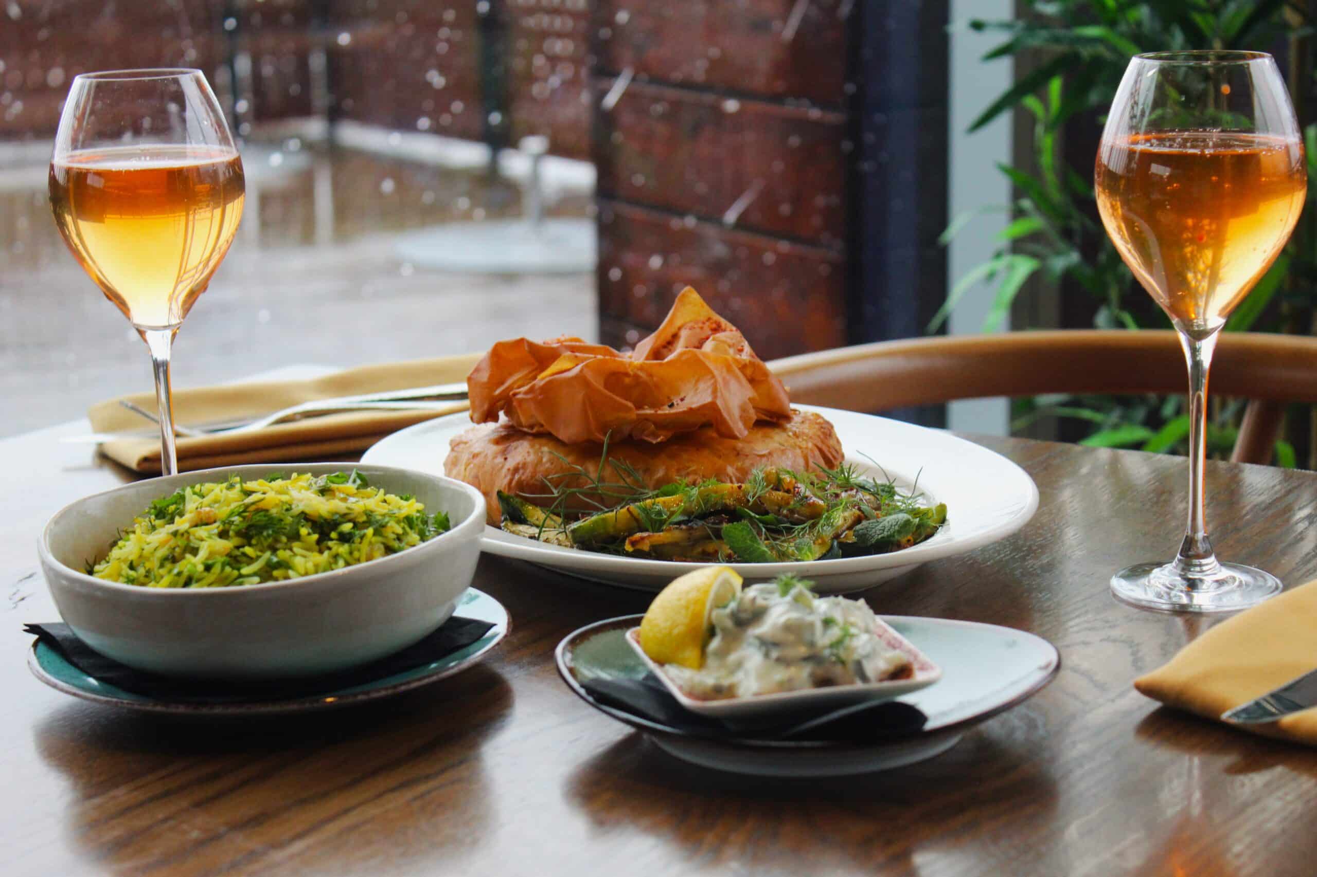 A table set for two with the harbour in the background