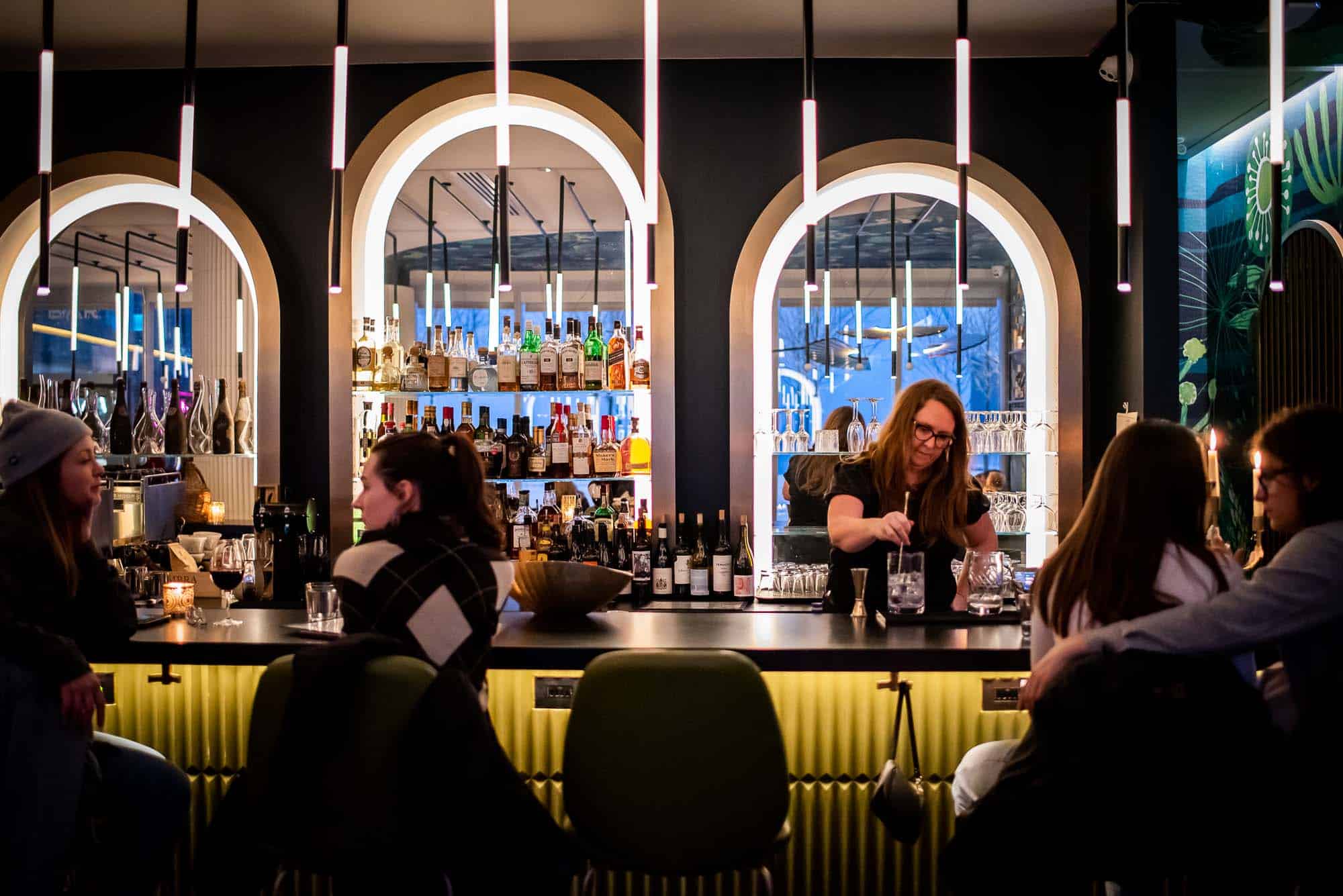 Guests sitting at the bar at Peacock Wine Bar