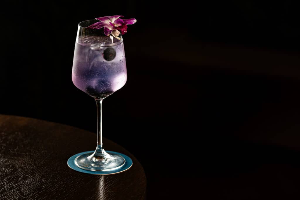Purple cocktail against a dark background at Darya in Halifax